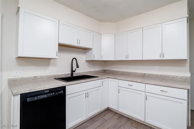 kitchen featuring dishwasher, light hardwood / wood-style flooring, sink, and white cabinetry