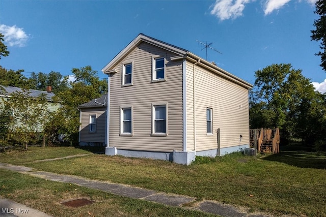 view of home's exterior with a lawn