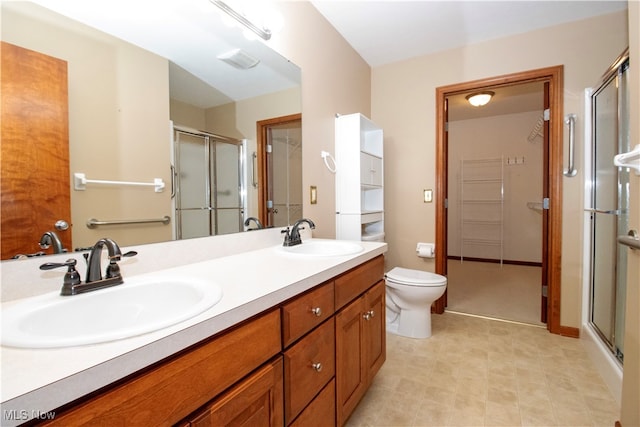 bathroom with an enclosed shower, vanity, and toilet