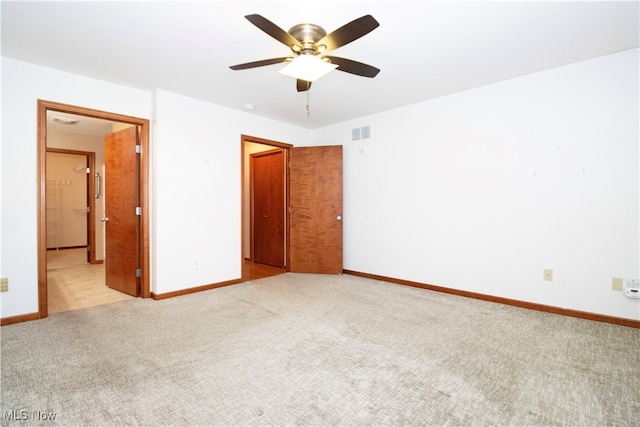 unfurnished bedroom featuring light carpet and ceiling fan