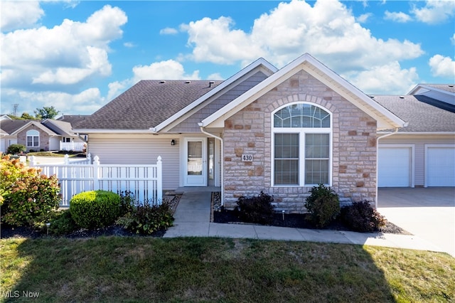 view of front of home with a garage and a front yard