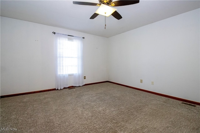 carpeted spare room featuring ceiling fan