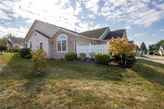 2452 Barrington Way Unit 430, Wooster, OH 44691 - view of side of property with a yard, stone siding, and fence