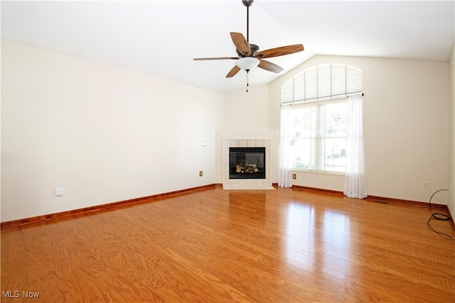 unfurnished living room featuring a fireplace, lofted ceiling, light hardwood / wood-style flooring, and ceiling fan