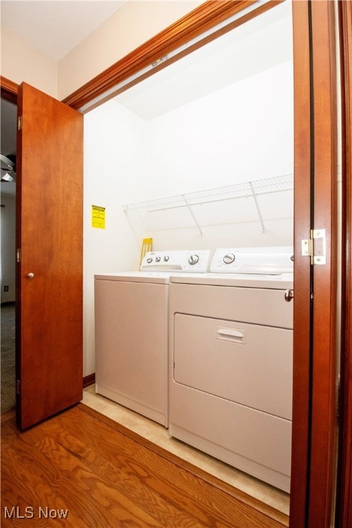 laundry area featuring light hardwood / wood-style floors and washer and clothes dryer