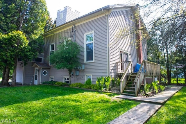 view of side of home with a yard