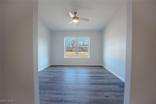 spare room with ceiling fan and dark hardwood / wood-style flooring