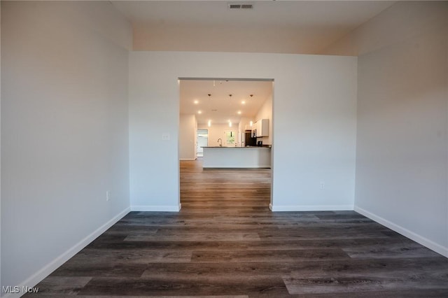 spare room featuring dark hardwood / wood-style floors