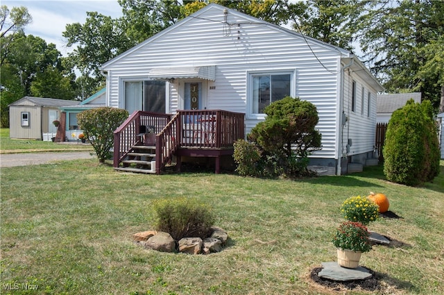 bungalow-style home featuring a shed and a front yard