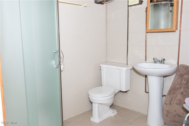 bathroom with toilet and tile patterned floors