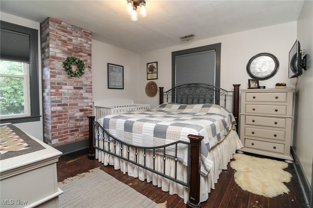 bedroom with dark hardwood / wood-style flooring