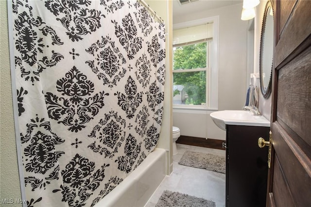 full bathroom featuring vanity, shower / tub combo, and toilet