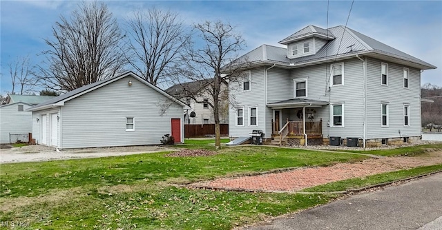 rear view of property featuring a lawn and central AC unit