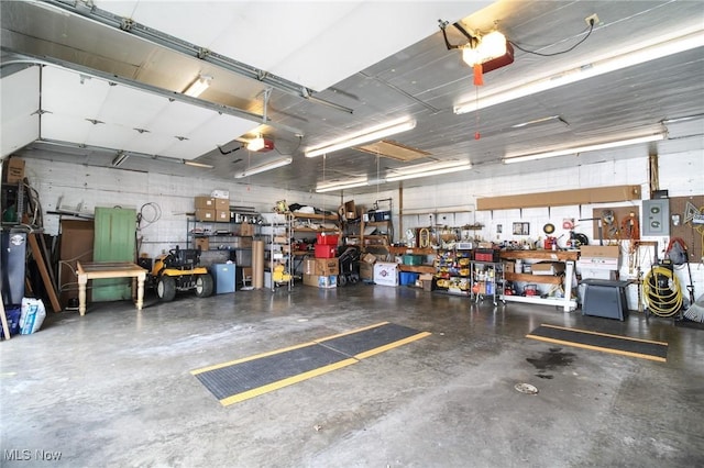 garage with a workshop area and a garage door opener