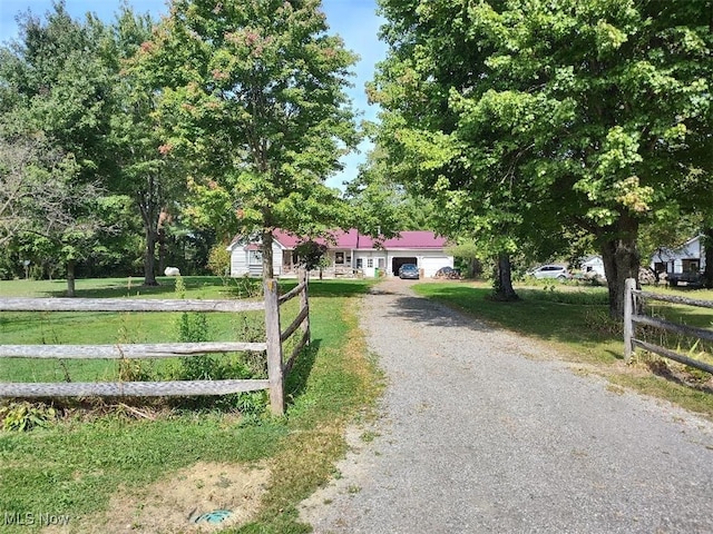 3445 Shaffer Rd, Rock Creek, OH 44084 - view of front facade with driveway, fence, an attached garage, and a front lawn