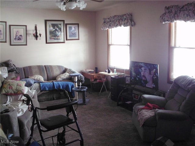 carpeted living room with ceiling fan