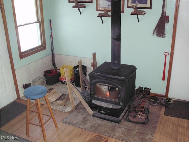 details with wood-type flooring and a wood stove