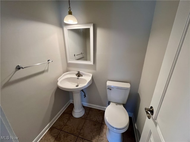 bathroom with toilet and tile patterned floors