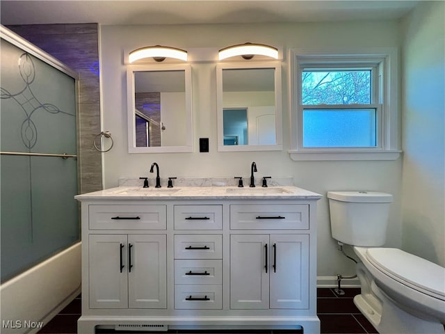 bathroom with tile patterned flooring, vanity, and toilet