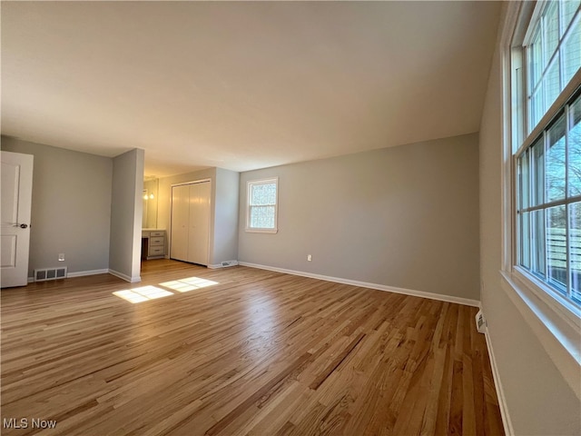 unfurnished living room with light wood-type flooring