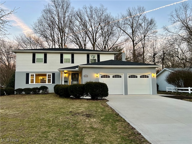 view of front property with a lawn and a garage