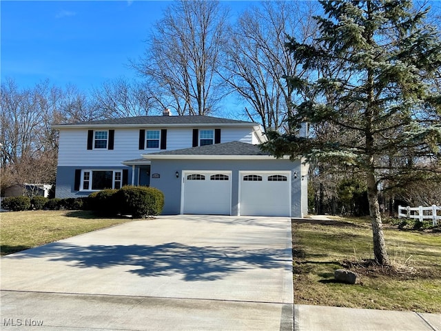 view of front facade with a garage and a front lawn