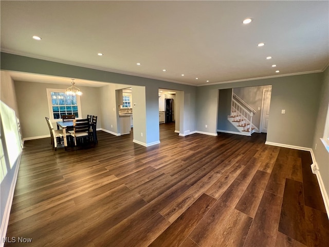 living room with an inviting chandelier, crown molding, and dark hardwood / wood-style flooring