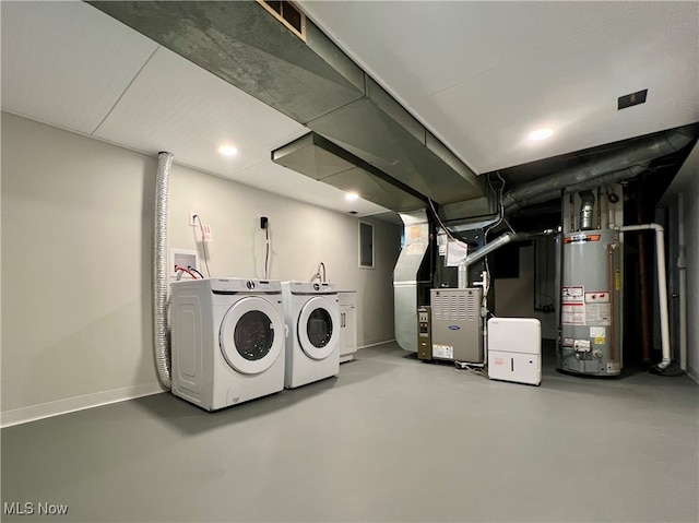 laundry room featuring gas water heater, heating unit, and independent washer and dryer