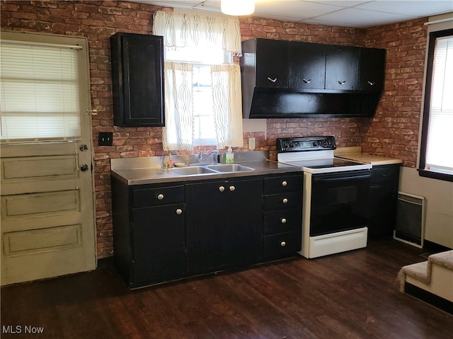 kitchen with stainless steel counters, white electric range oven, sink, and a wealth of natural light