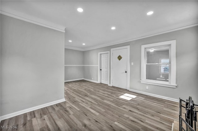 entrance foyer with light hardwood / wood-style floors and crown molding