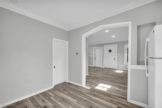 spare room featuring ornamental molding and hardwood / wood-style flooring