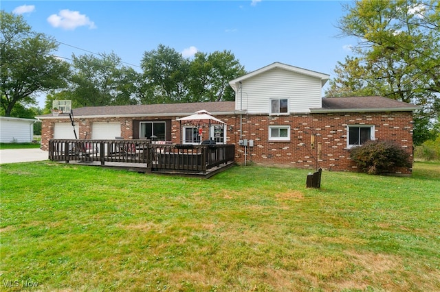 rear view of property with a garage, a deck, and a yard