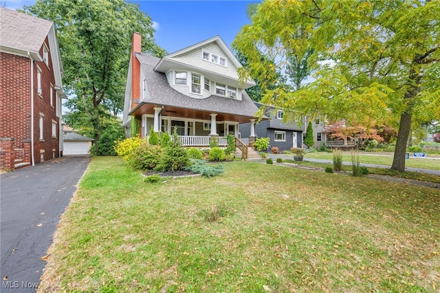 view of front facade with a front yard and covered porch