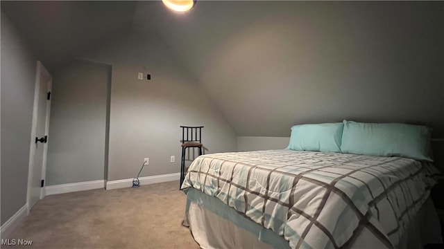 carpeted bedroom with vaulted ceiling