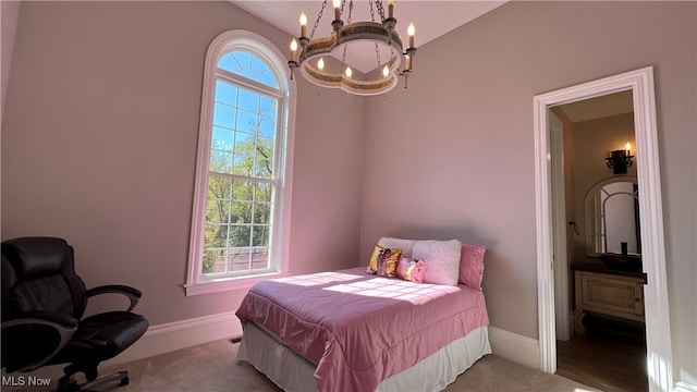 bedroom with multiple windows, an inviting chandelier, and light colored carpet