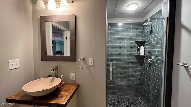 bathroom with vanity and tiled shower