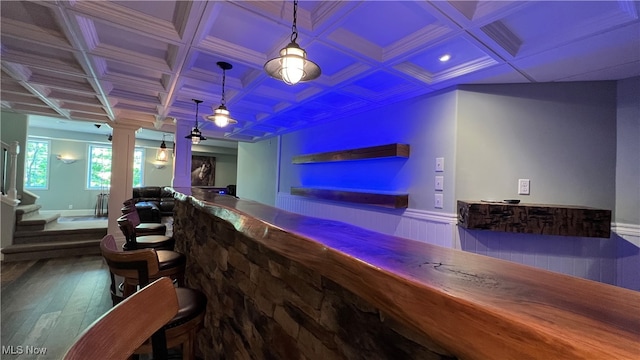 bar featuring coffered ceiling, hardwood / wood-style flooring, beamed ceiling, and hanging light fixtures