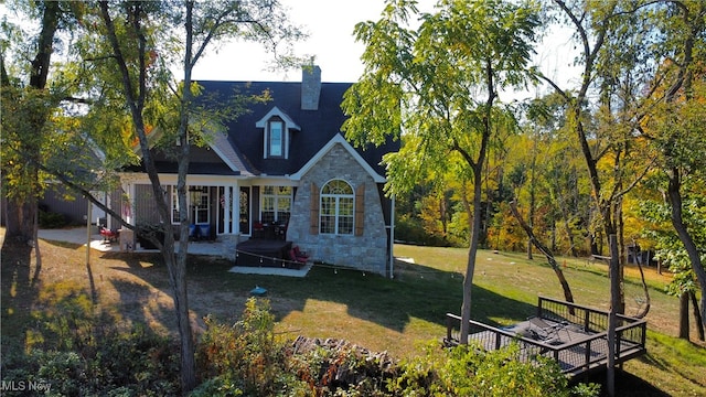 rear view of property featuring a lawn