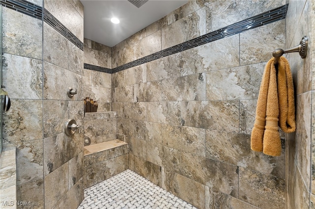 bathroom with a tile shower