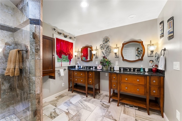 bathroom with vanity and a tile shower