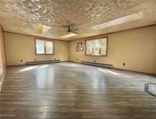 unfurnished room with ornamental molding, ceiling fan, baseboard heating, and dark hardwood / wood-style floors