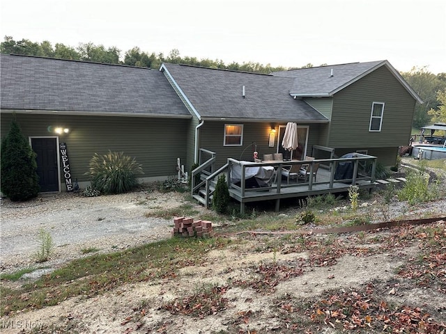 back of property featuring a deck