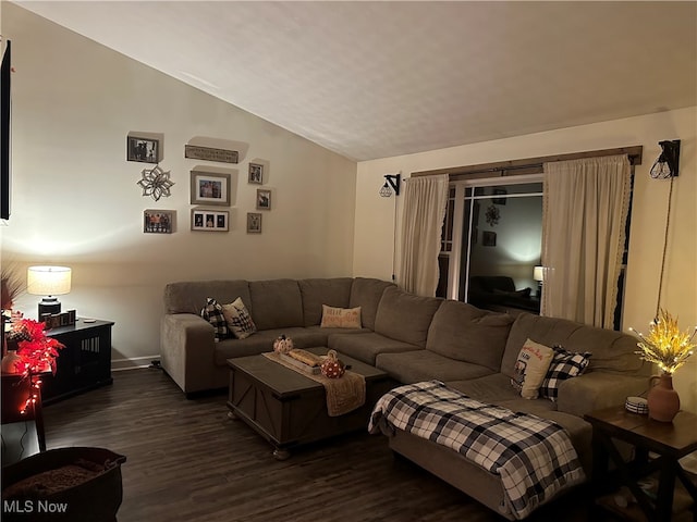 living room with dark wood-type flooring and lofted ceiling