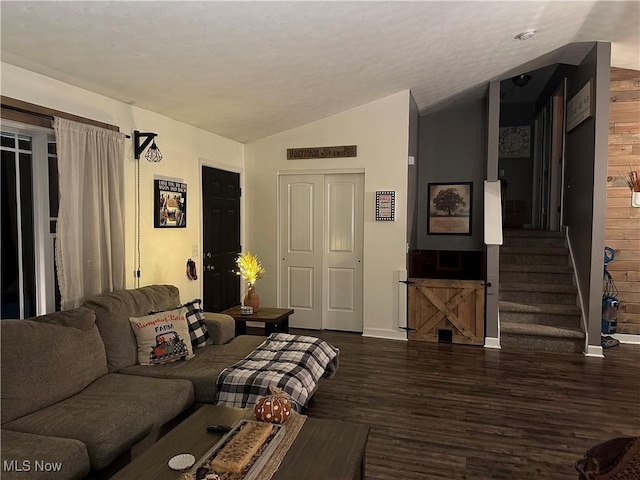 living room featuring dark hardwood / wood-style flooring and vaulted ceiling