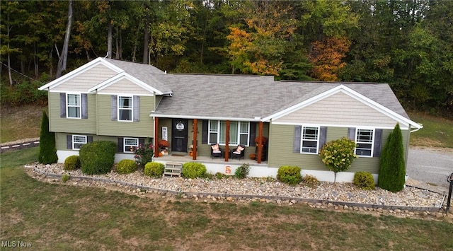 view of front of home featuring covered porch and a front yard