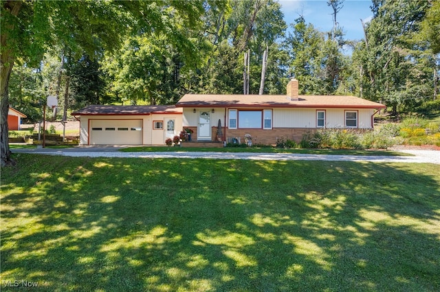 ranch-style house featuring a front yard and a garage