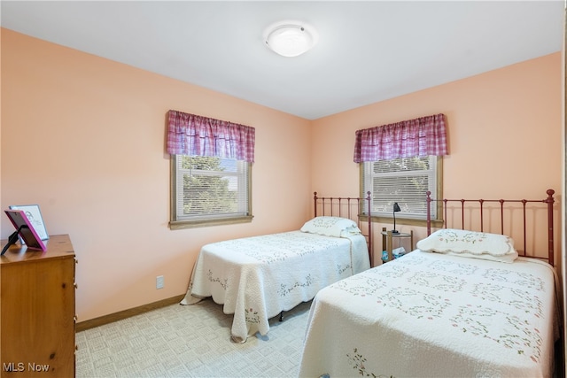 carpeted bedroom with multiple windows