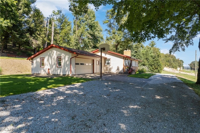 view of front of property with a garage and a front lawn