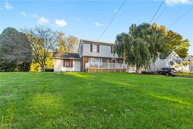 view of front of property with a front lawn and a deck