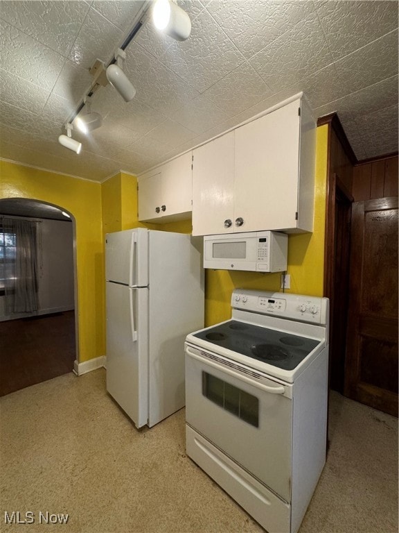 kitchen with a textured ceiling, rail lighting, white appliances, and white cabinets